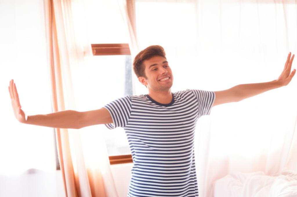 man feeling energetic and happy in the morning